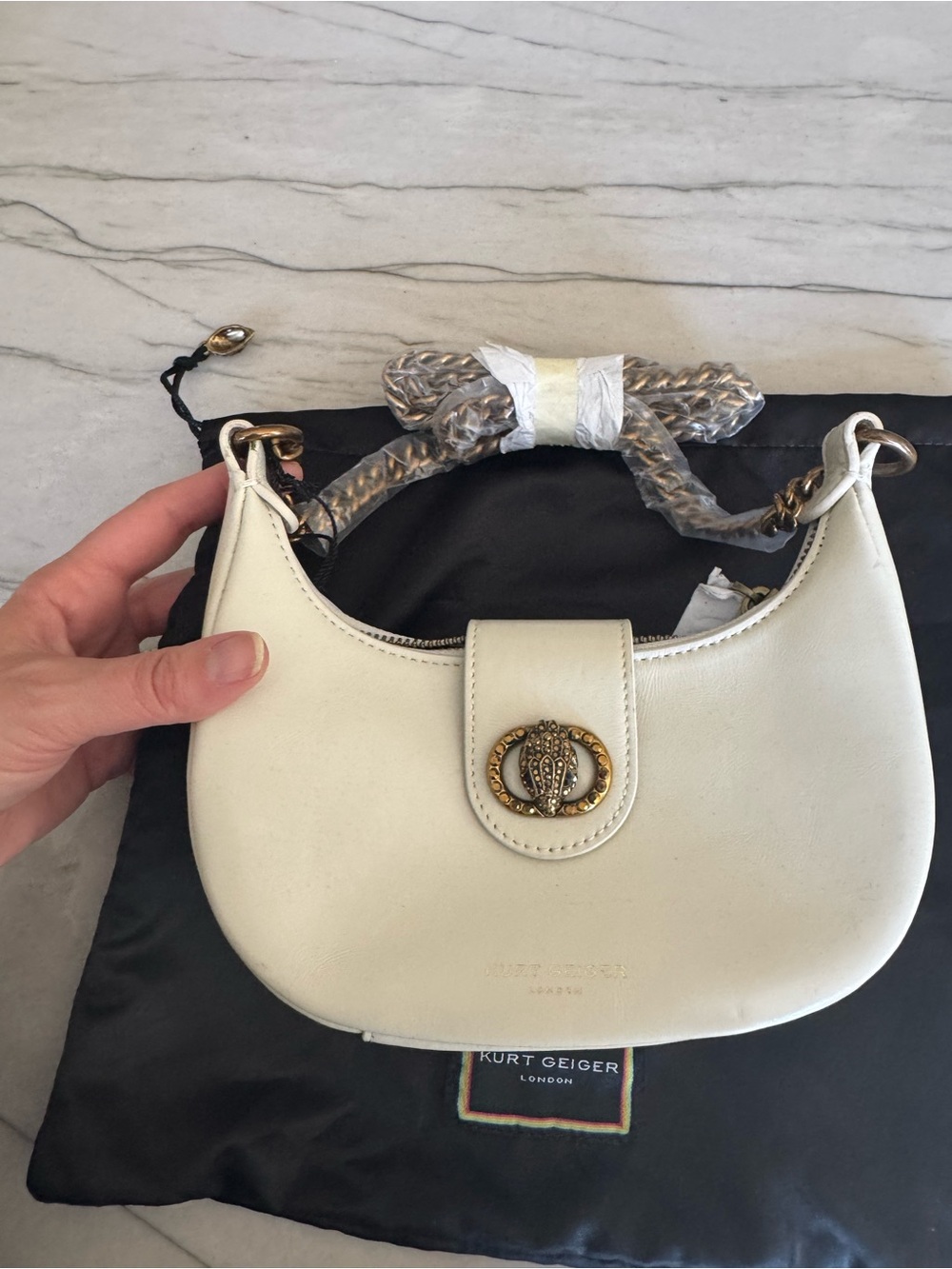 Kurt Geiger Cream Leather Crescent Shoulder Bag with Gold Emblem